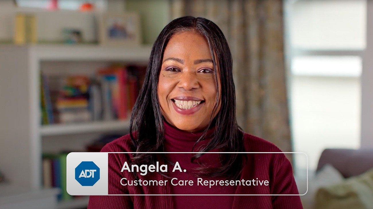 Angela, an ADT Customer Care Representative smiling at the camera