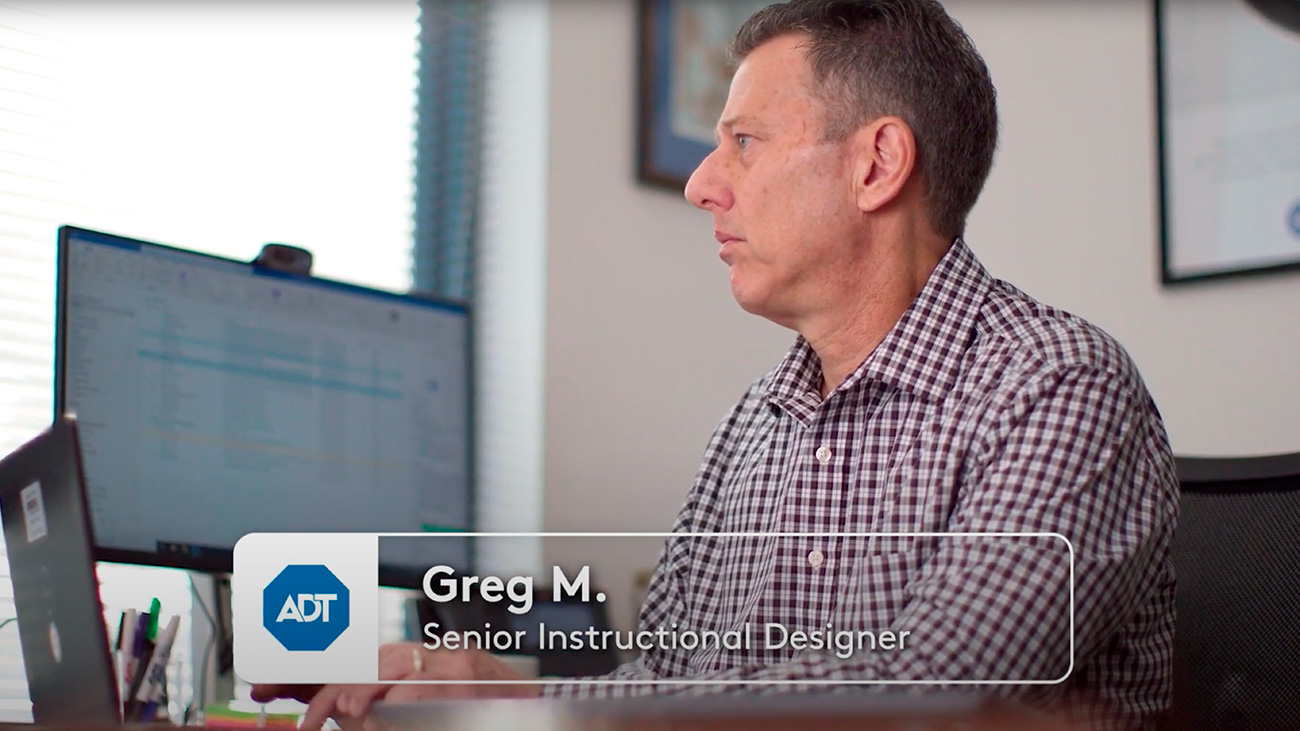 Greg M., ADT Senior Instructional Designer, working on a computer.