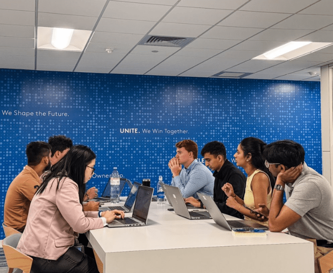Interns sitting around a table at ADT's headquarters in Boca Raton, FL